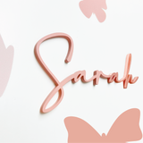 Pink 'Sarah' Name Signage with butterfly designs on a white background