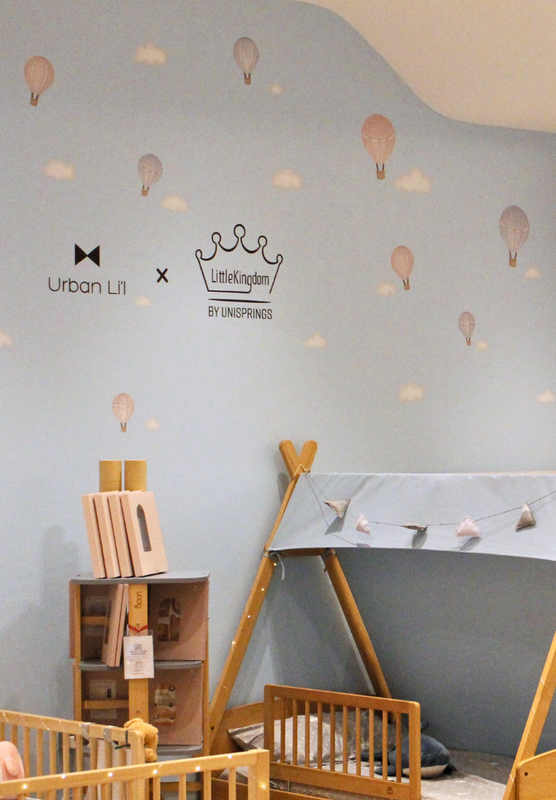 Children's room with furniture and decor, featuring a bed and toys.